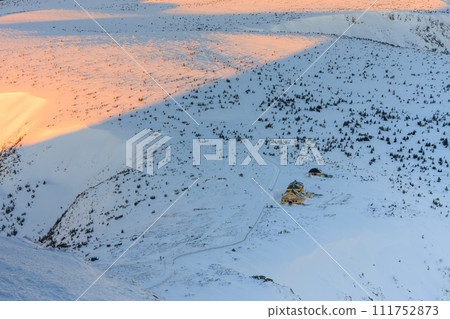 Winter, sunrise time, view from Snezka to Silesian house, krkonose mountains. Snezka is mountain on the border between Czech Republic and Poland. 111752873