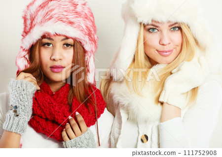 Two girls in warm winter clothing portrait. 111752908