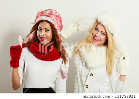 Two smiling girls in warm winter clothing. Two smiling girls in warm winter clothing. 111752921