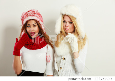 Two girls warm winter clothing having fun. 111752927
