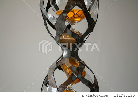 Stylish hourglass. Sand running in an hourglass, measuring the countdown time on a dark background 111753139