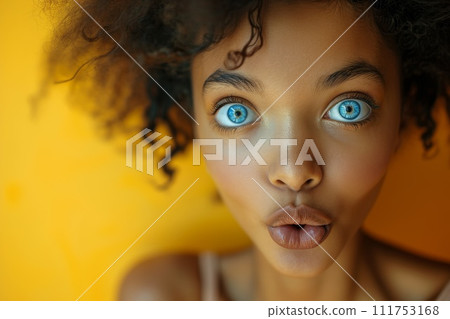 The young girl made a grimace with her lips, and stared at the orange background The young girl made a grimace with her lips, and stared at the orange background 111753168