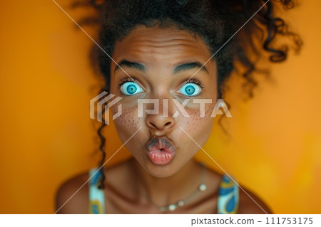 The young girl made a grimace with her lips, and stared at the orange background The young girl made a grimace with her lips, and stared at the orange background 111753175