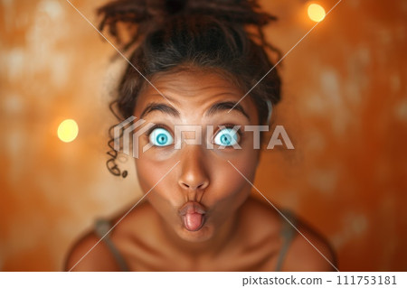 The young girl made a grimace with her lips, and stared at the orange background 111753181