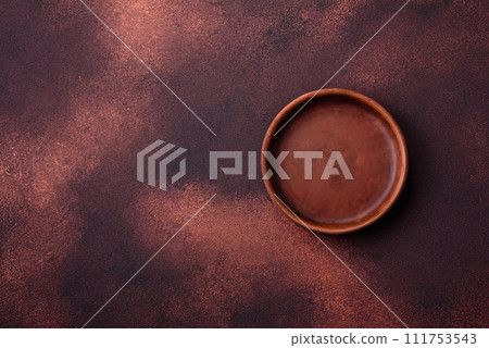 Empty ceramic round plate on dark textured concrete background 111753543
