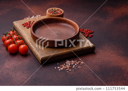 Empty ceramic round plate on dark textured concrete background 111753544