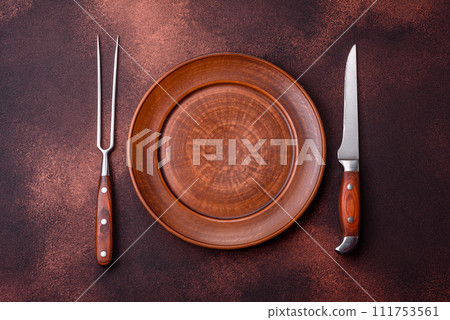 Empty ceramic round plate on dark textured concrete background 111753561