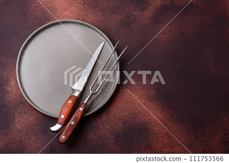 Empty ceramic round plate on dark textured concrete background 111753566