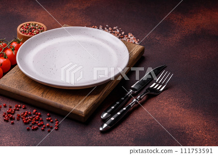 Empty ceramic round plate on dark textured concrete background Empty ceramic round plate on dark textured concrete background 111753591