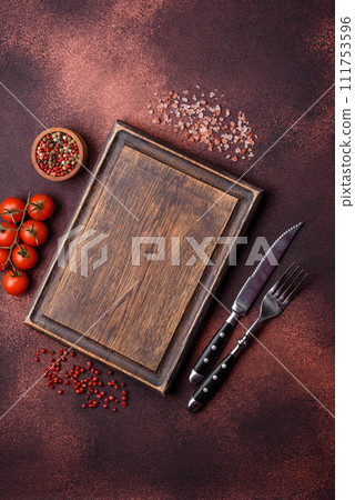 Empty rectangular wooden cutting board on textured concrete background Empty rectangular wooden cutting board on textured concrete background 111753596