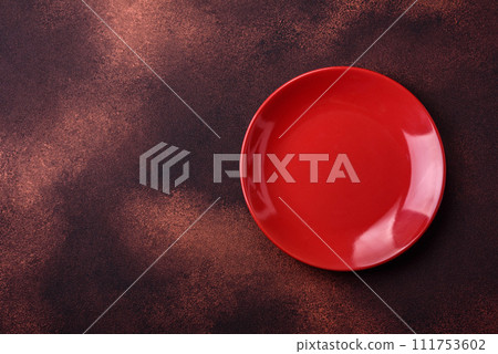 Empty ceramic round plate on dark textured concrete background Empty ceramic round plate on dark textured concrete background 111753602