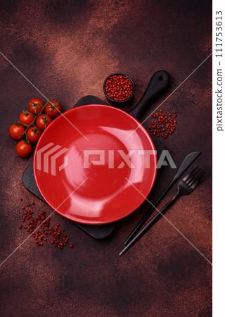 Empty ceramic round plate on dark textured concrete background 111753613