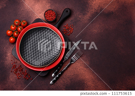 Empty ceramic round plate on dark textured concrete background Empty ceramic round plate on dark textured concrete background 111753615