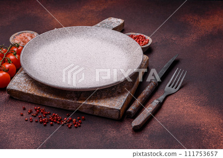 Empty ceramic round plate on dark textured concrete background 111753657