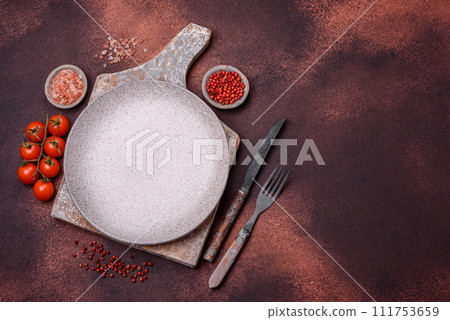 Empty ceramic round plate on dark textured concrete background Empty ceramic round plate on dark textured concrete background 111753659
