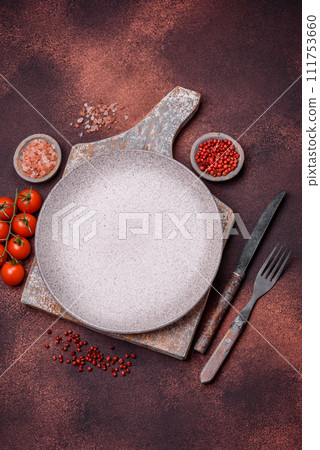 Empty ceramic round plate on dark textured concrete background 111753660