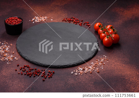 Empty ceramic round plate on dark textured concrete background Empty ceramic round plate on dark textured concrete background 111753661