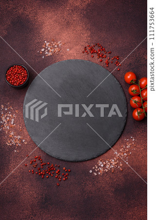Empty ceramic round plate on dark textured concrete background 111753664