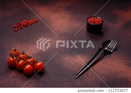 Empty concrete kitchen surface with salt, allspice and cherry tomatoes, copy space 111753677