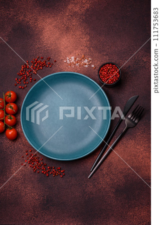 Empty ceramic round plate on dark textured concrete background 111753683