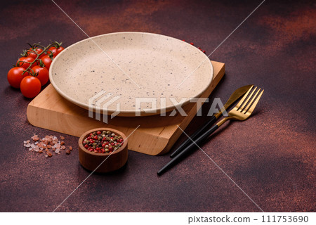 Empty ceramic round plate on dark textured concrete background 111753690