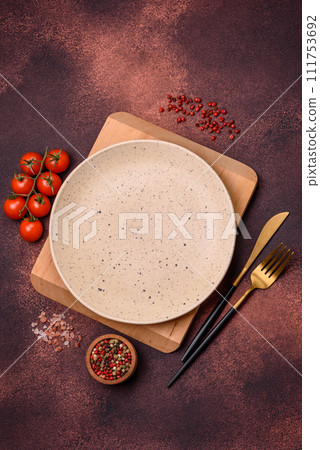 Empty ceramic round plate on dark textured concrete background 111753692