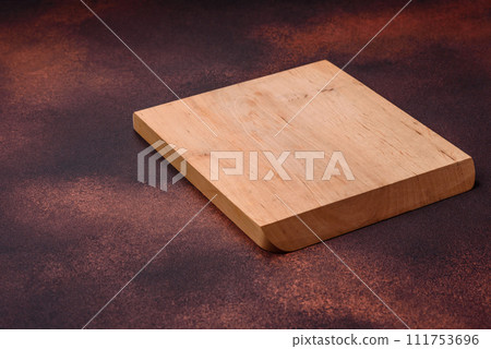 Empty rectangular wooden cutting board on textured concrete background Empty rectangular wooden cutting board on textured concrete background 111753696