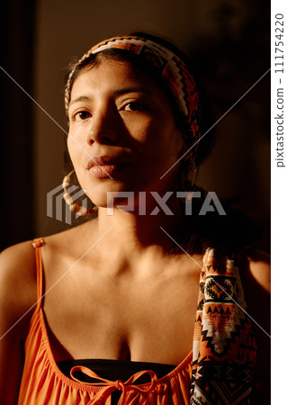 Woman in ethnic headscarf and earrings Woman in ethnic headscarf and earrings 111754220