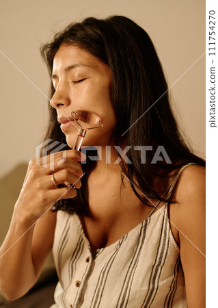 Skincare procedure with jade roller 111754270