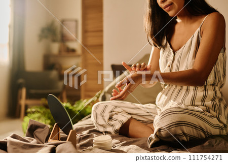 Woman in pajamas taking care of hands 111754271