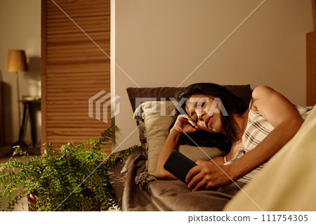 Girl looking at screen of mobile gadget 111754305