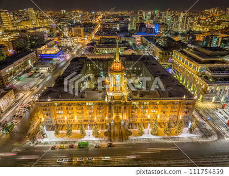 Yekaterinburg City Administration or City Hall and Central square at winter nigh. Night city in winter or early spring. Aerial View. Yekaterinburg City Administration or City Hall and Central square at winter nigh. Night city in winter or early spring. Aerial View. 111754859