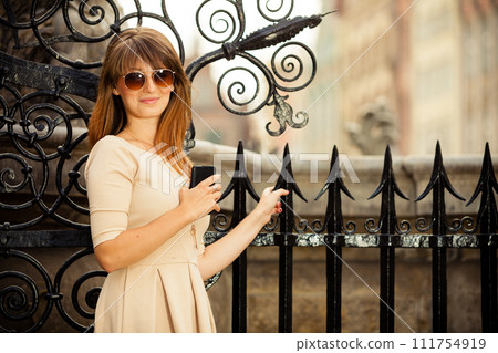fashion girl with smart phone outdoors 111754919