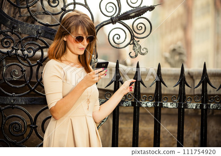 fashion girl with smart phone outdoors 111754920