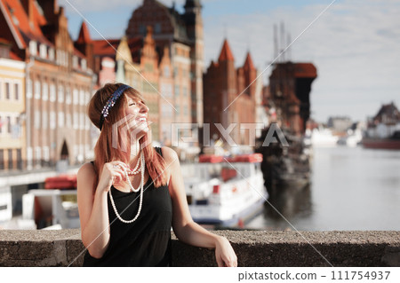 Flapper girl woman in1920s style standing on the street Flapper girl woman in1920s style standing on the street 111754937