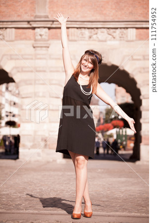 Flapper girl woman in1920s style standing on the street 111754952