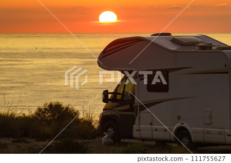 Caravan on sea at sunrise. 111755627