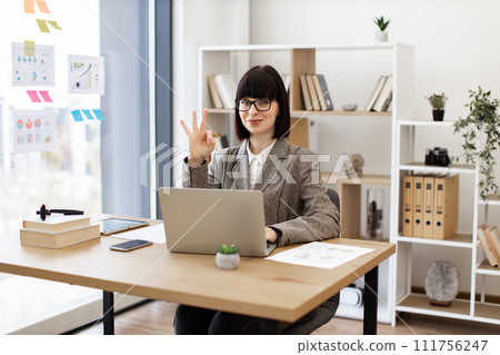 Caucasian female worker investigating trademarks using search engine. 111756247
