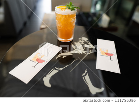 beautiful and delicious alcoholic cocktails prepared at the bar by the bartender. 111756386