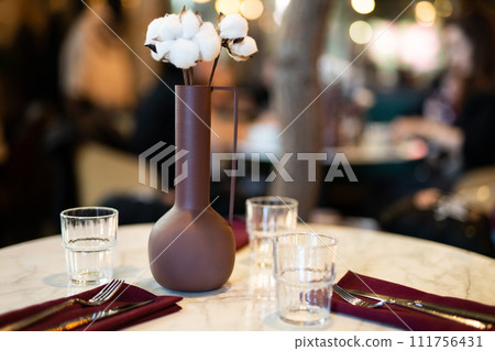 beautiful vase with cotton flowers on the table. 111756431