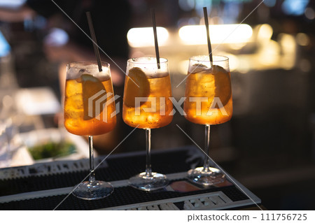 the bartender prepares a beautiful alcoholic cocktail at the bar counter 111756725