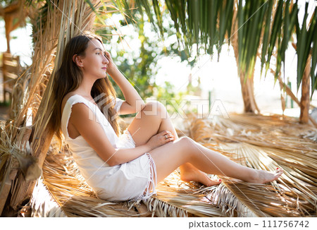 beautiful sexy girl alone in the jungle among leaves and trees. 111756742