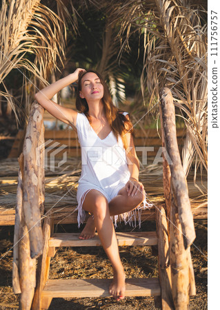 beautiful sexy girl alone in a bungalow on the seashore 111756757