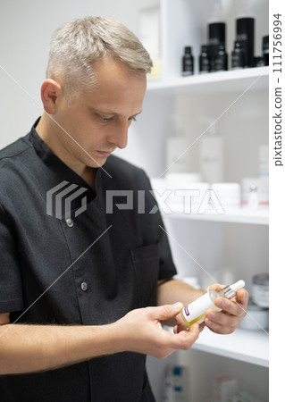 man doctor, cosmetologist holds drugs in his hands man doctor, cosmetologist holds drugs in his hands 111756994
