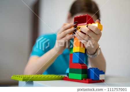 a small child plays with a constructor while building 111757001