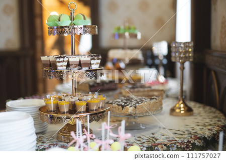 Delicious sweet cakes and desserts at the festive candy bar Delicious sweet cakes and desserts at the festive candy bar 111757027