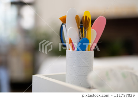 a set of brushes and various cosmetologist accessories in a cup a set of brushes and various cosmetologist accessories in a cup 111757029