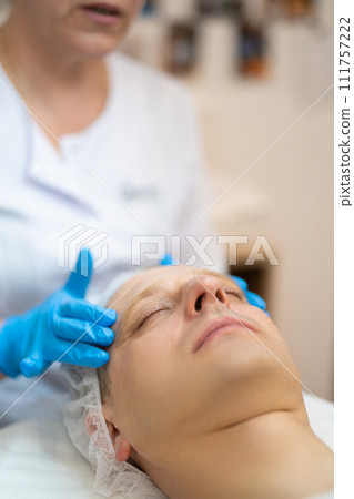 cosmetic procedures on a man's face in a beauty salon 111757222