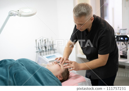 girl at a cosmetologist during treatment procedures girl at a cosmetologist during treatment procedures 111757231