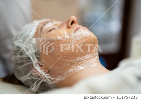 close-up of a girl's face at a cosmetologist during treatment procedures close-up of a girl's face at a cosmetologist during treatment procedures 111757238